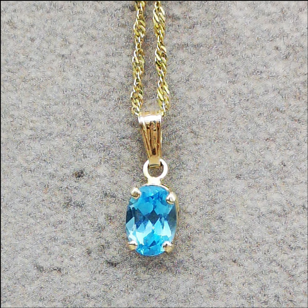 10ct Gold Blue Topaz Pendant on a 9ct Gold Chain