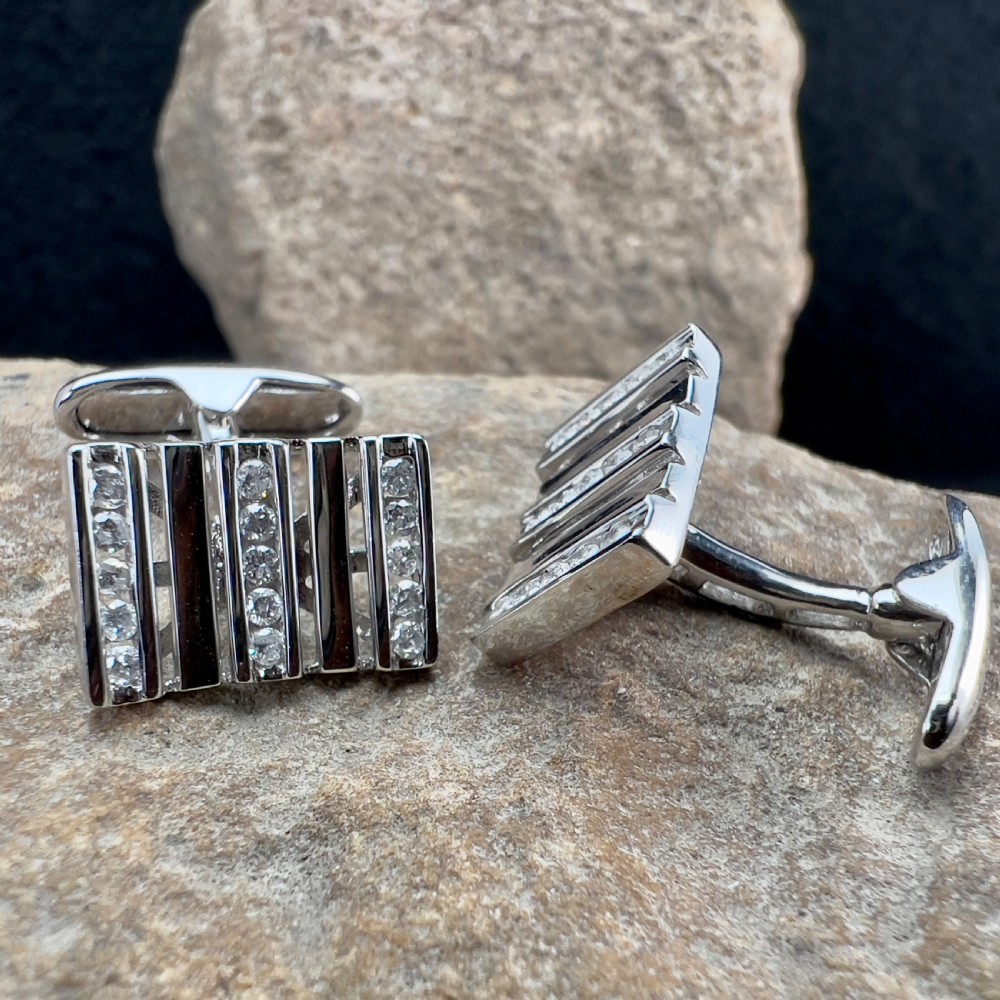 A pair of rectangular 9ct white gold cufflinks featuring alternating polished vertical bars and channel-set diamonds. View II