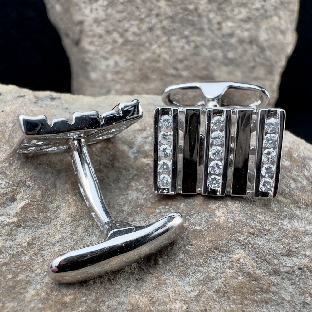 A pair of rectangular 9ct white gold cufflinks featuring alternating polished vertical bars and channel-set diamonds. View III
