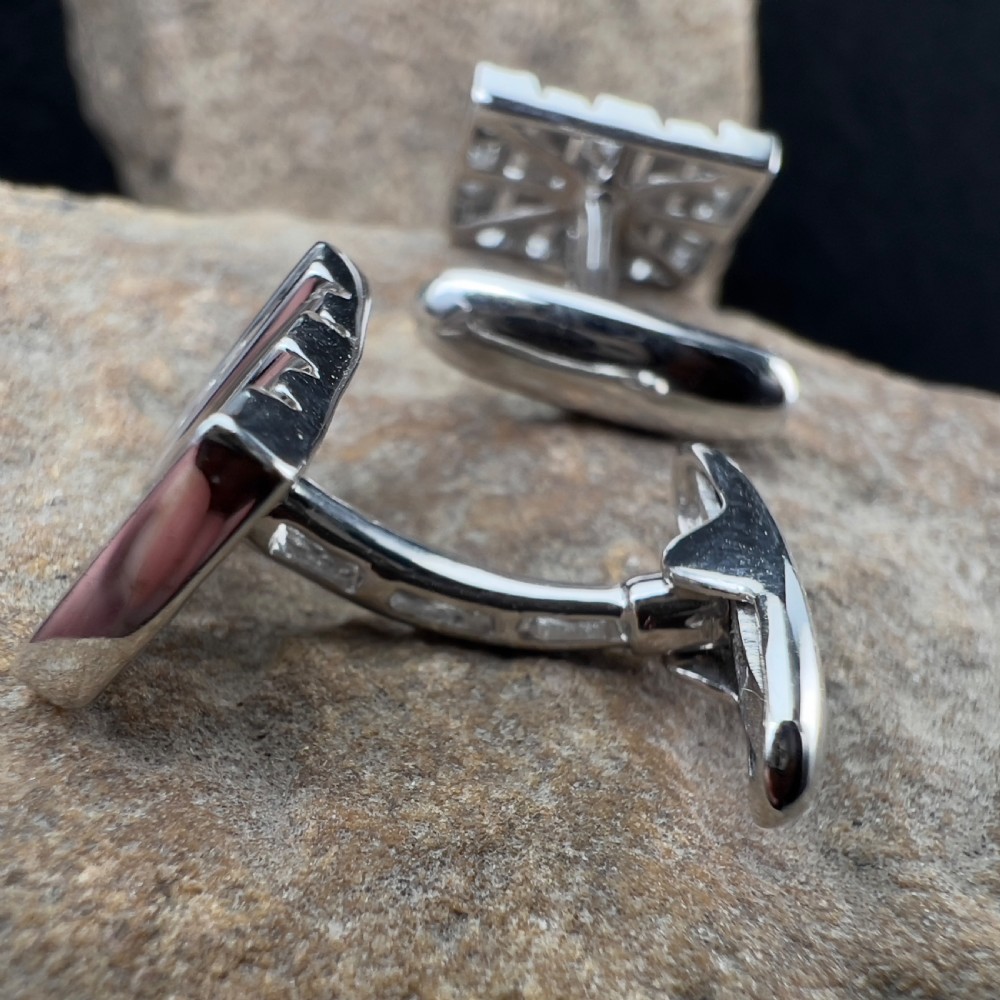 A pair of rectangular 9ct white gold cufflinks featuring alternating polished vertical bars and channel-set diamonds. View V