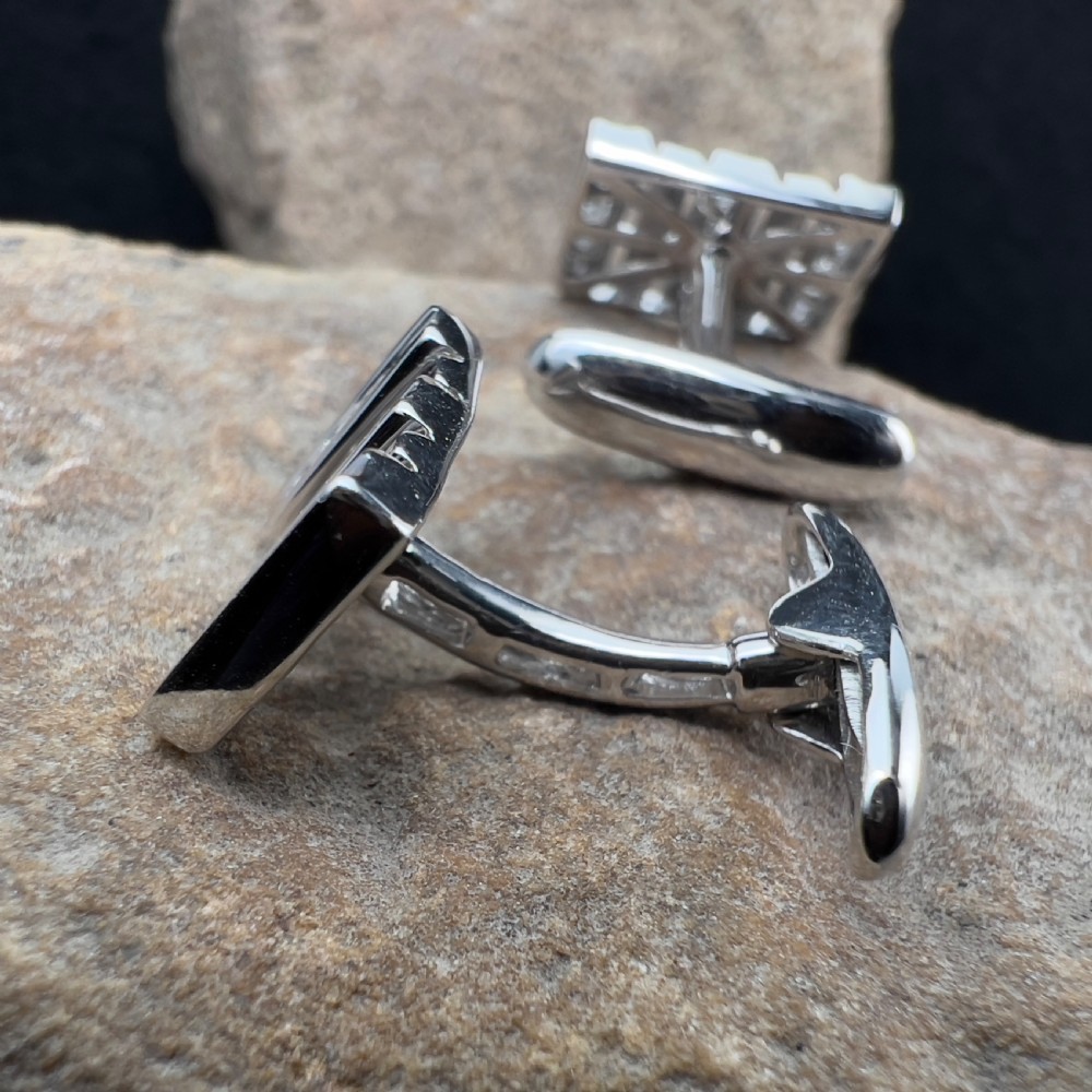 A pair of rectangular 9ct white gold cufflinks featuring alternating polished vertical bars and channel-set diamonds. View VI