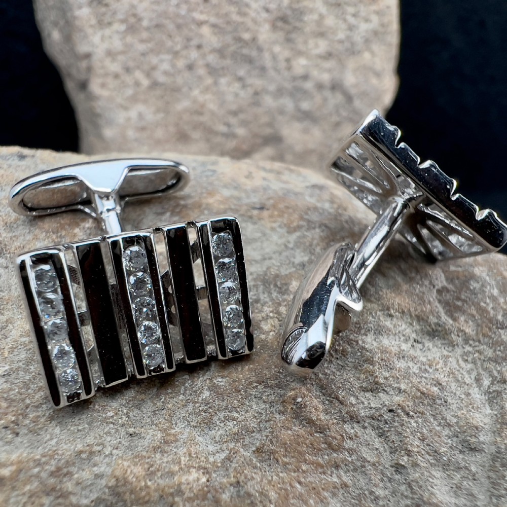 A pair of rectangular 9ct white gold cufflinks featuring alternating polished vertical bars and channel-set diamonds. View VIII