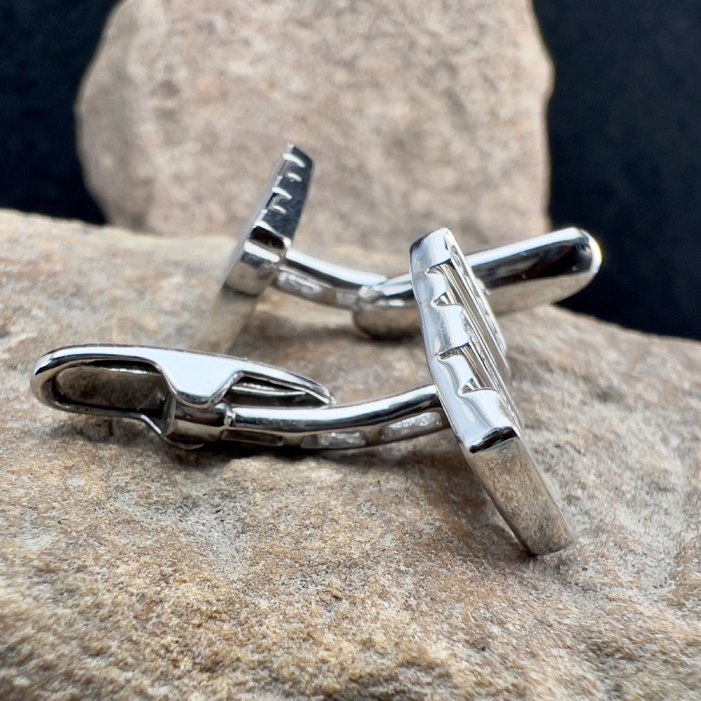 A pair of rectangular 9ct white gold cufflinks featuring alternating polished vertical bars and channel-set diamonds. View X