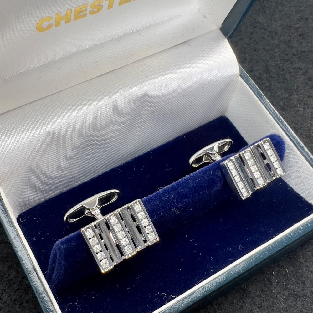 A pair of rectangular 9ct white gold cufflinks featuring alternating polished vertical bars and channel-set diamonds. View XIV