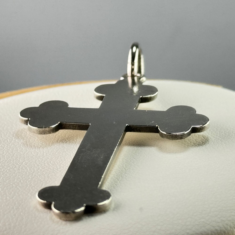 An antique sterling silver crucifix pendant featuring trefoil terminals, a polished metal surface, and visible British hallmarks near the base. View III