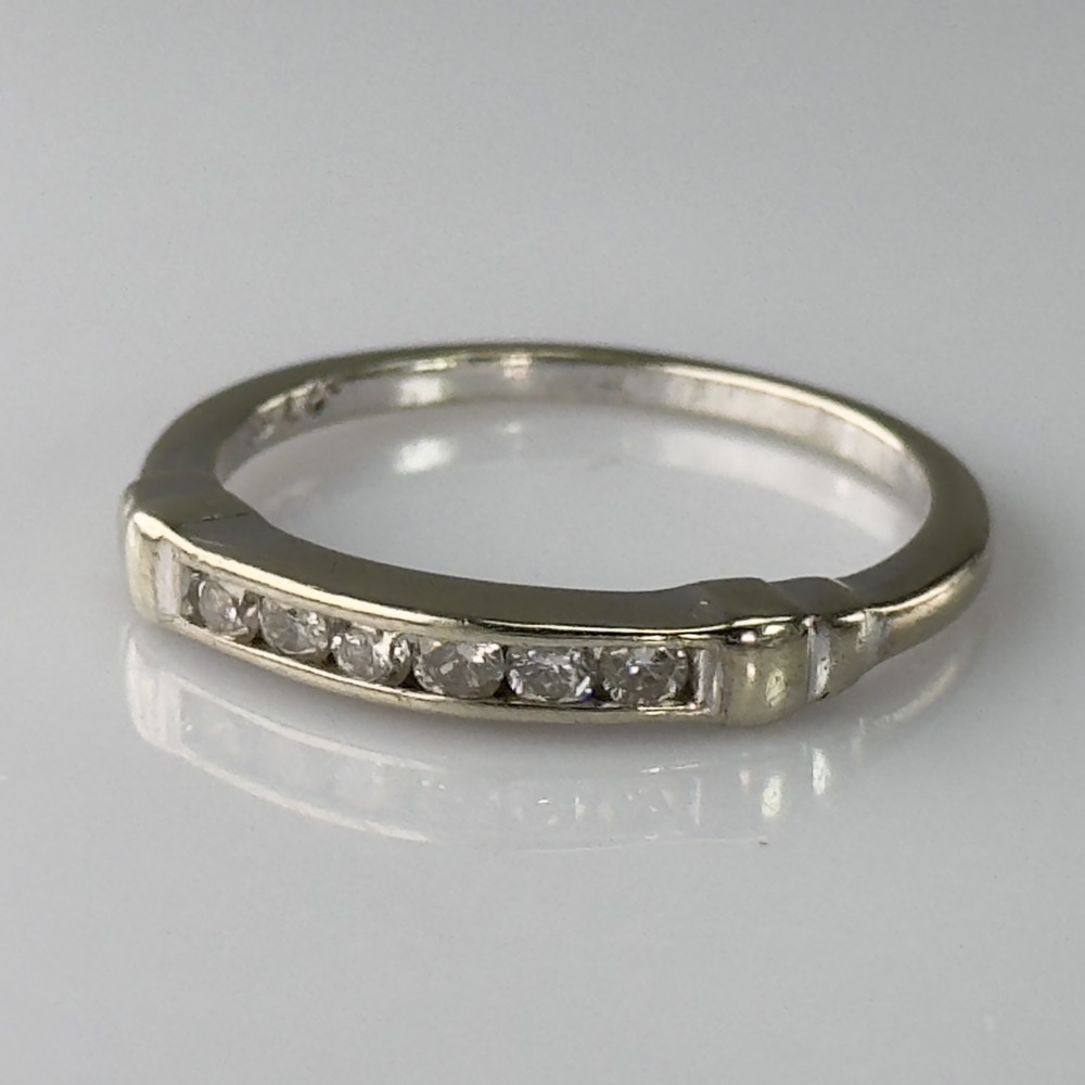 A 9ct gold half eternity ring featuring a channel-set row of round diamonds along the band.