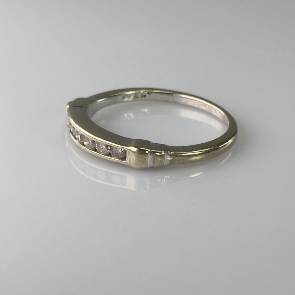 A 9ct gold half eternity ring featuring a channel-set row of round diamonds along the band. View V