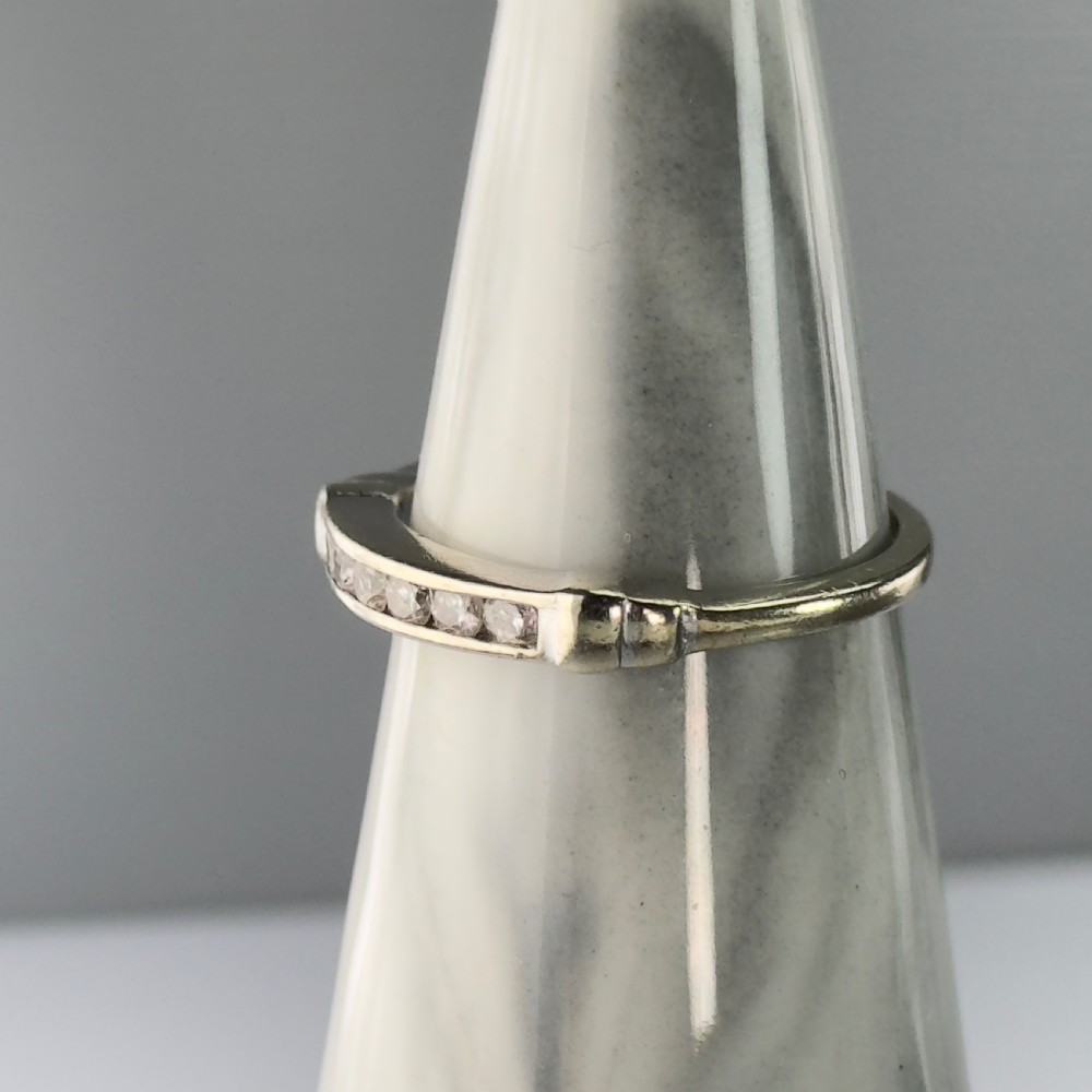 A 9ct gold half eternity ring featuring a channel-set row of round diamonds along the band. View VIII