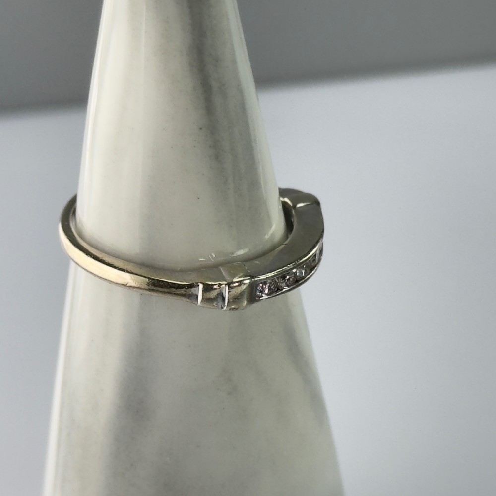 A 9ct gold half eternity ring featuring a channel-set row of round diamonds along the band. View IX