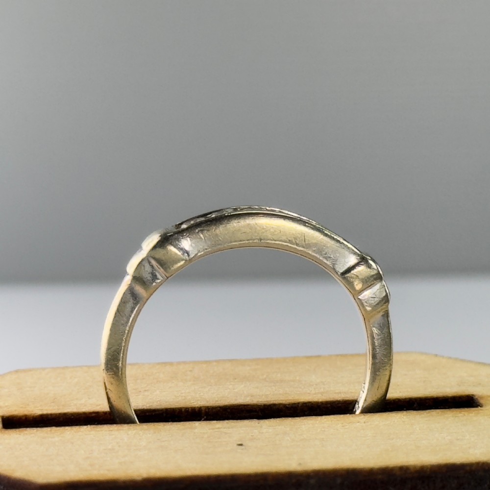 A 9ct gold half eternity ring featuring a channel-set row of round diamonds along the band. View X