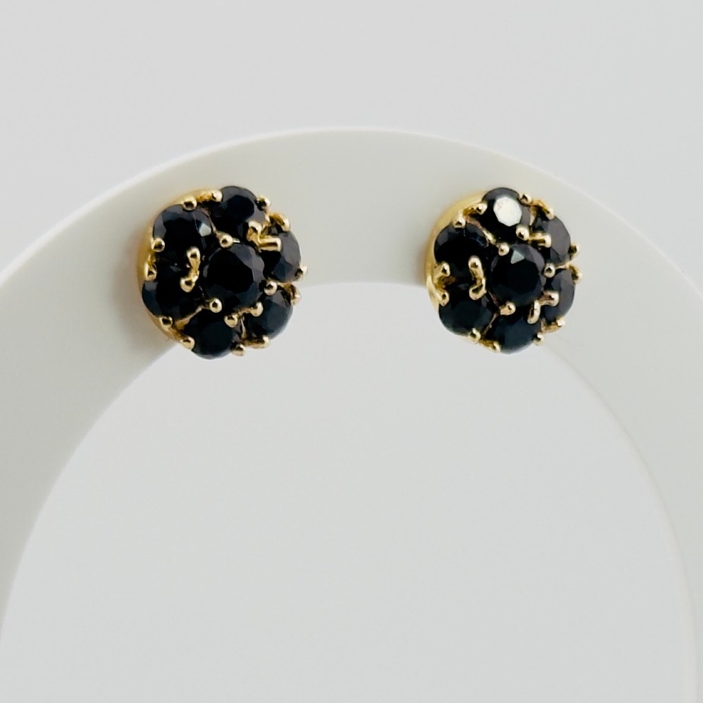 A pair of round 9ct yellow gold cluster stud earrings set with dark blue faceted sapphires in multi-claw settings.