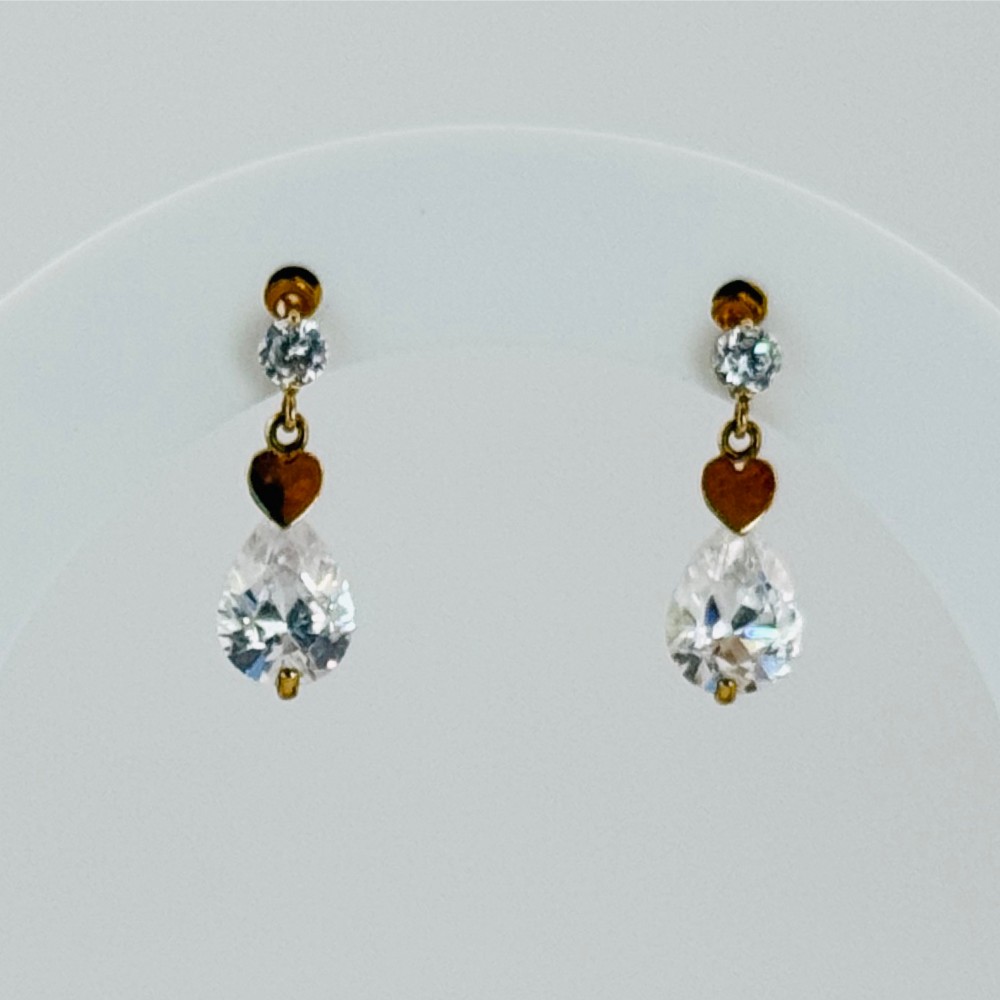 A pair of yellow gold drop earrings featuring top stud settings, central heart charms, and faceted teardrop crystals.