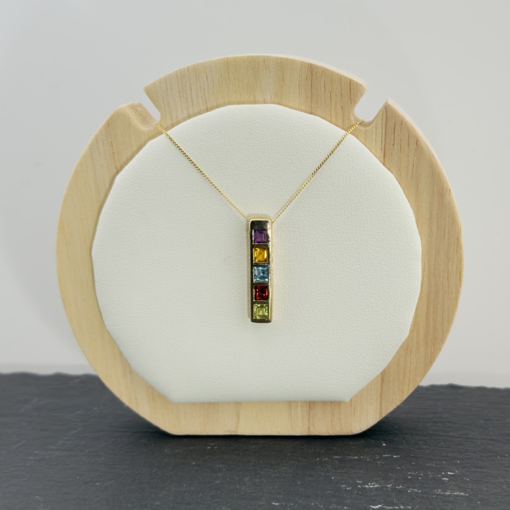 A 9ct yellow gold vertical bar pendant containing five square-cut multi-coloured gemstones suspended from a delicate gold chain. View VIII