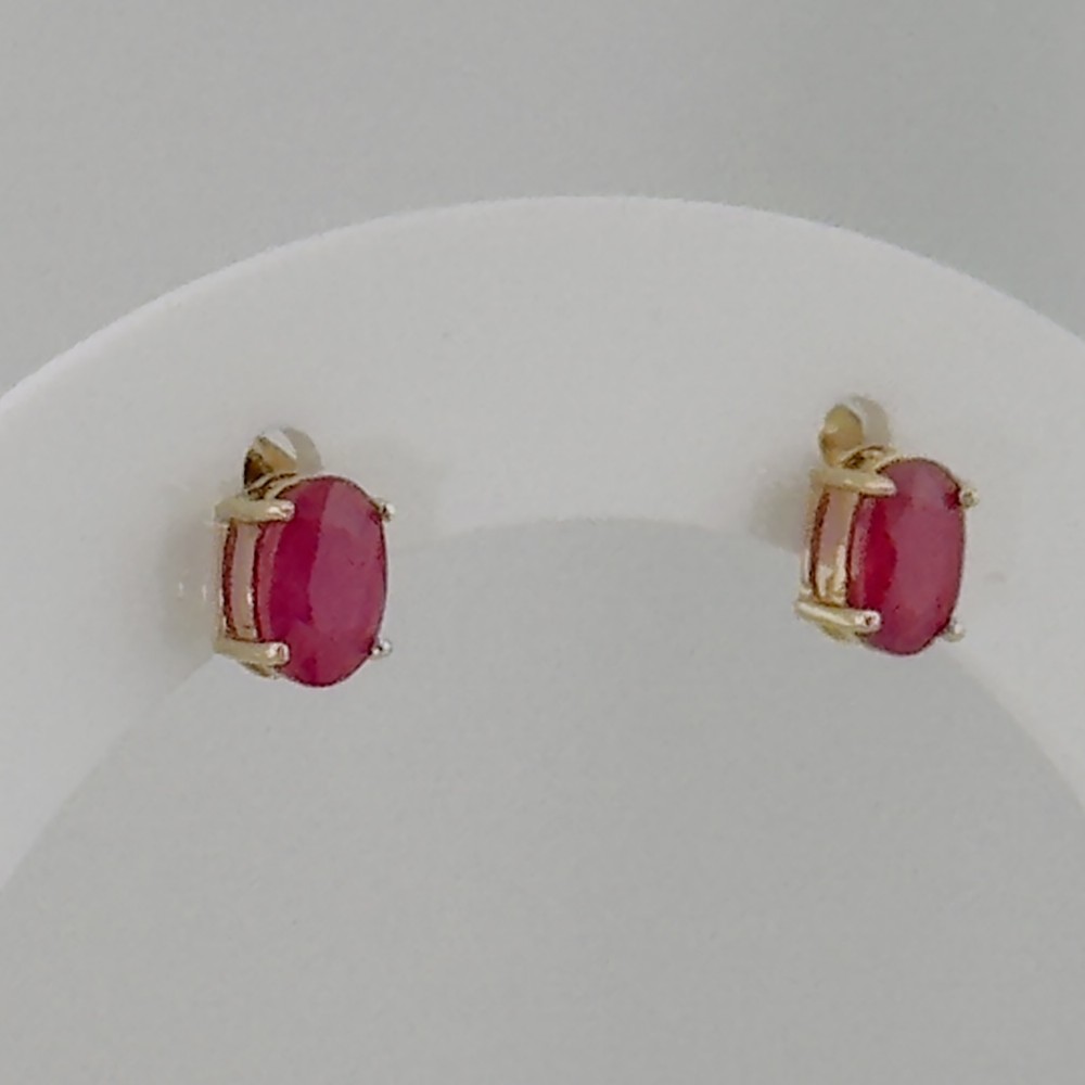 A pair of 9ct yellow gold stud earrings featuring oval-cut red rubies held in four-prong claw settings.