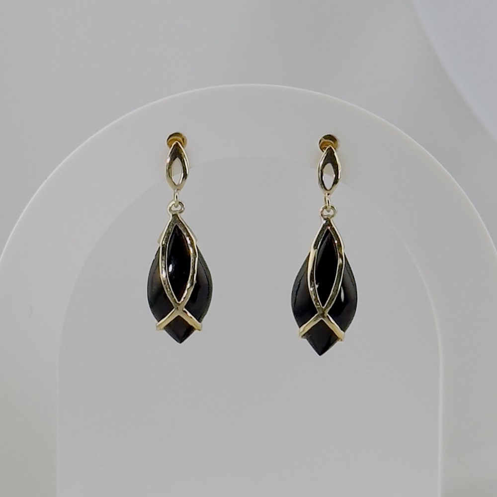 A pair of 9ct yellow gold drop earrings featuring teardrop-shaped polished black onyx stones encased in overlapping gold wirework.