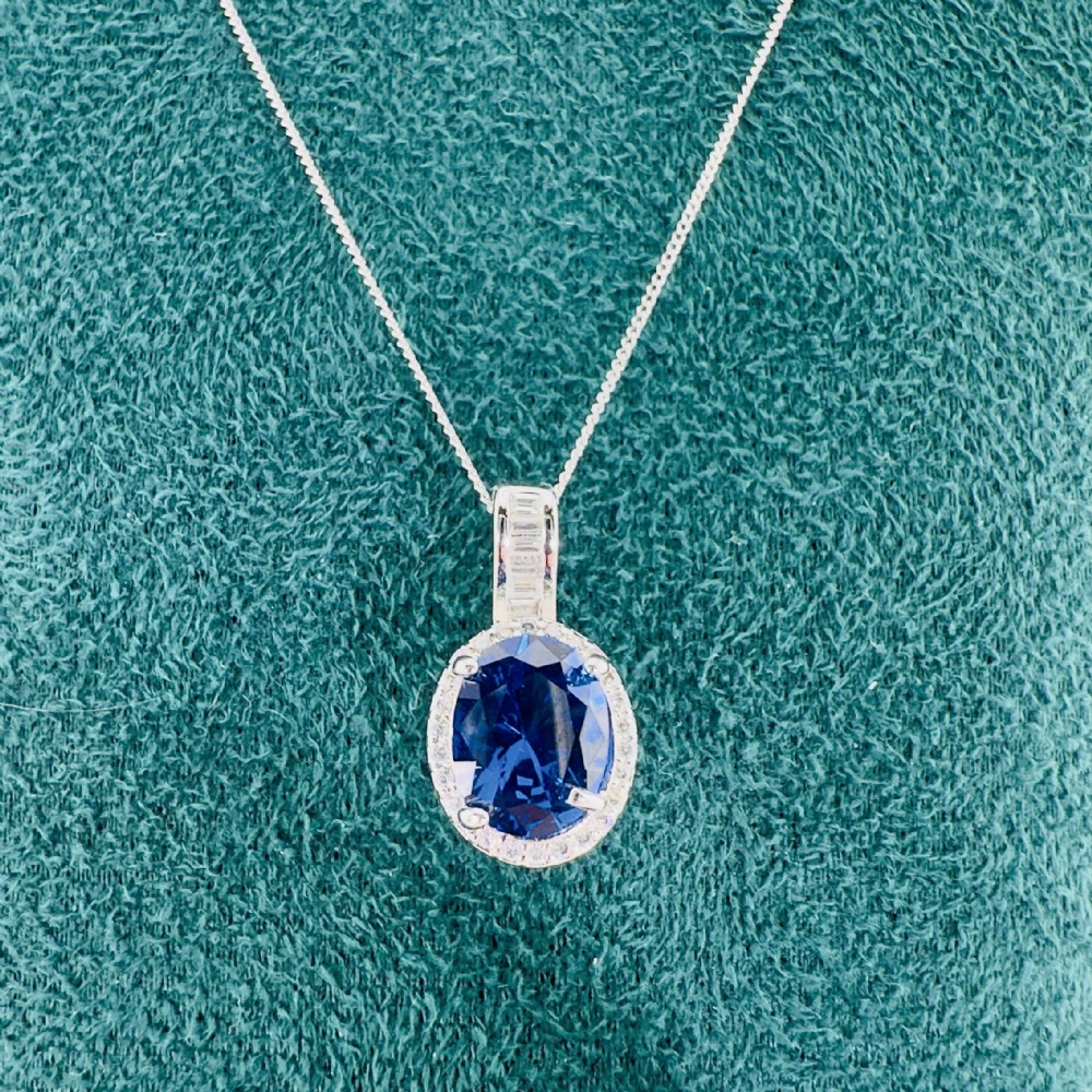 Platinum Oval Cut Sapphire and Diamond Cluster Pendant on White Gold Chain