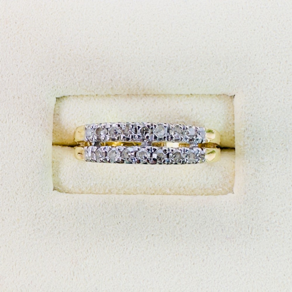 An 18ct yellow gold vintage ring featuring two parallel rows of small round diamonds set along a half-eternity band.