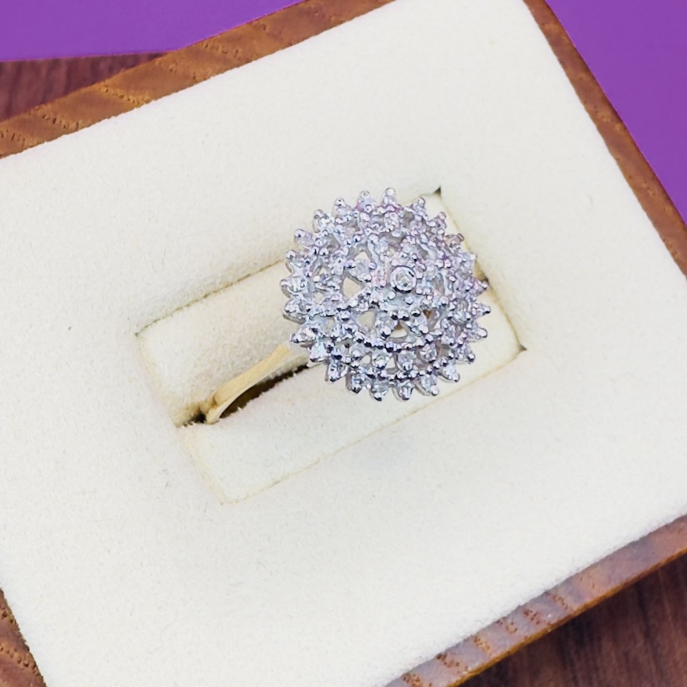 An 18ct yellow gold ring set with a circular arrangement of diamonds forming a tiered sunburst cluster motif.