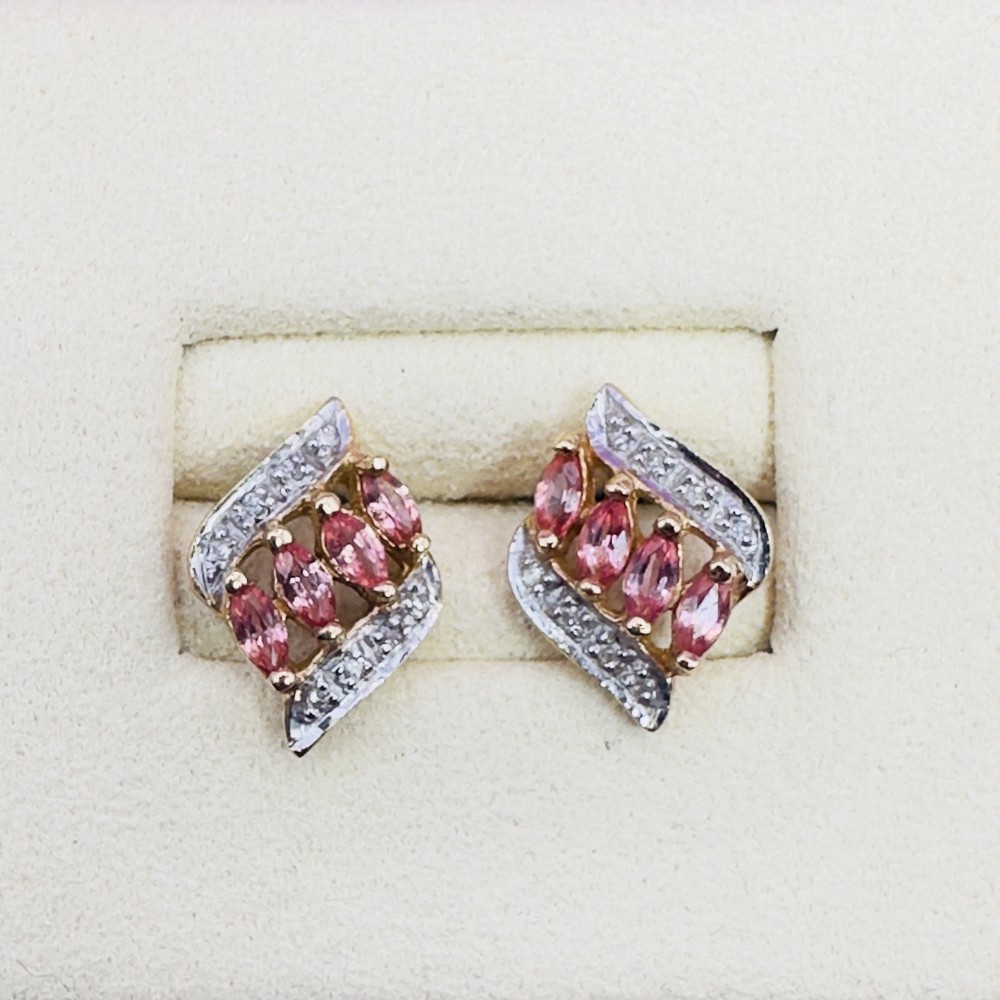 A pair of 18ct yellow gold stud earrings, each set with four marquise-cut pink padparadscha sapphires flanked by a swirl of diamonds.