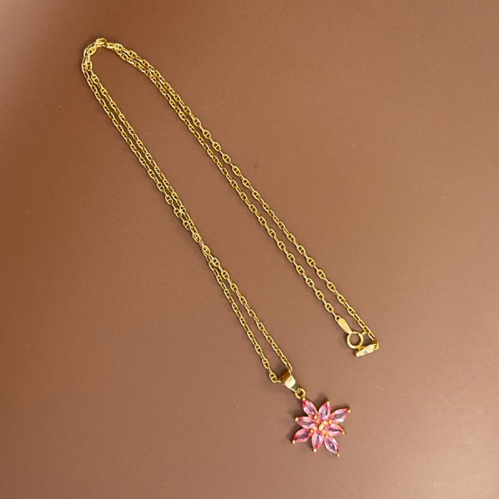 An 18ct yellow gold necklace featuring a starburst cluster pendant set with marquise-cut pinkish-orange Padparadscha sapphires. View XI