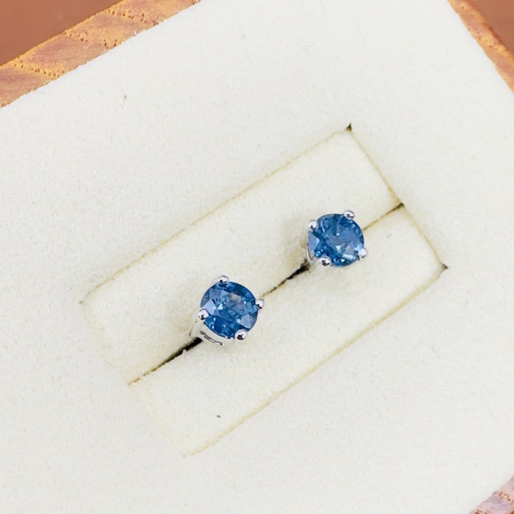 A pair of round blue sapphire stud earrings set in four-prong 18ct white gold mountings.