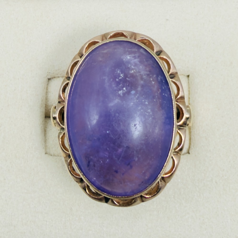 A vintage 14ct rose gold dress ring featuring a large oval cabochon lavender jade gemstone set within a scalloped gold gallery. View II
