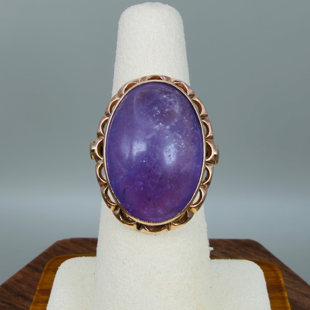 A vintage 14ct rose gold dress ring featuring a large oval cabochon lavender jade gemstone set within a scalloped gold gallery. View VI