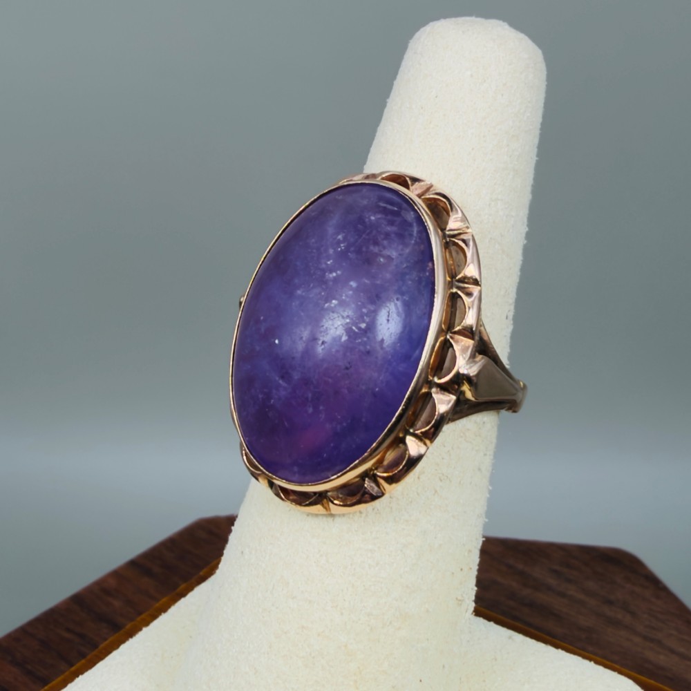 A vintage 14ct rose gold dress ring featuring a large oval cabochon lavender jade gemstone set within a scalloped gold gallery. View VII