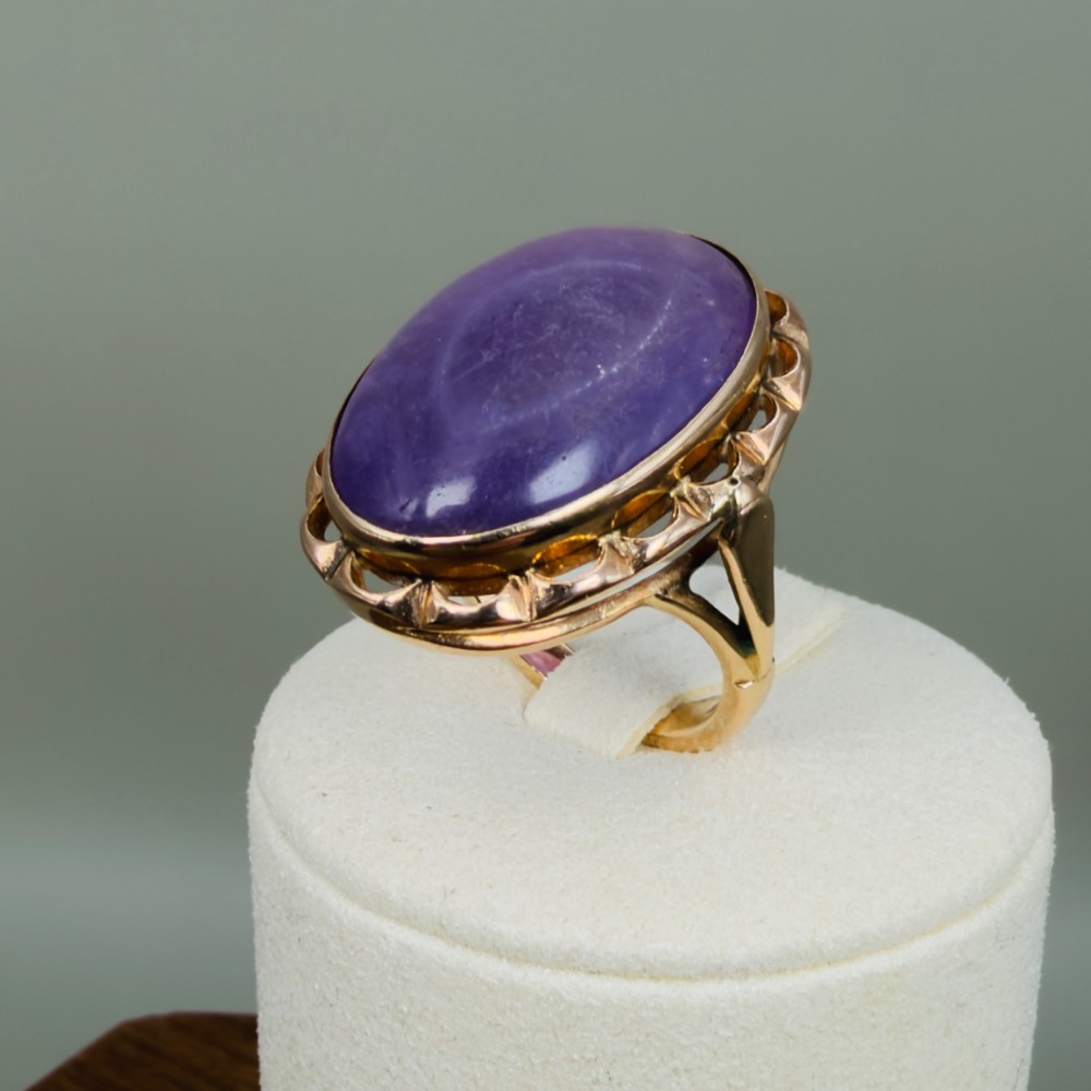 A vintage 14ct rose gold dress ring featuring a large oval cabochon lavender jade gemstone set within a scalloped gold gallery. View IX