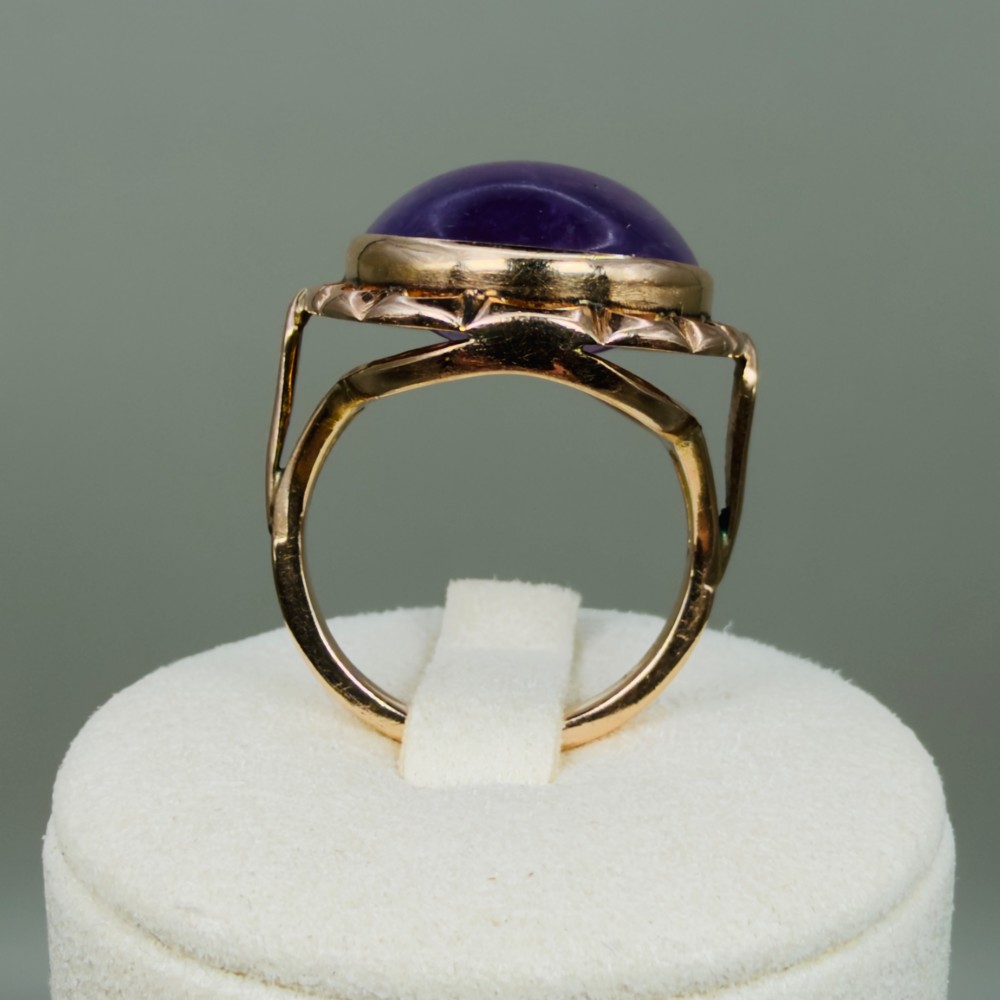 A vintage 14ct rose gold dress ring featuring a large oval cabochon lavender jade gemstone set within a scalloped gold gallery. View XI