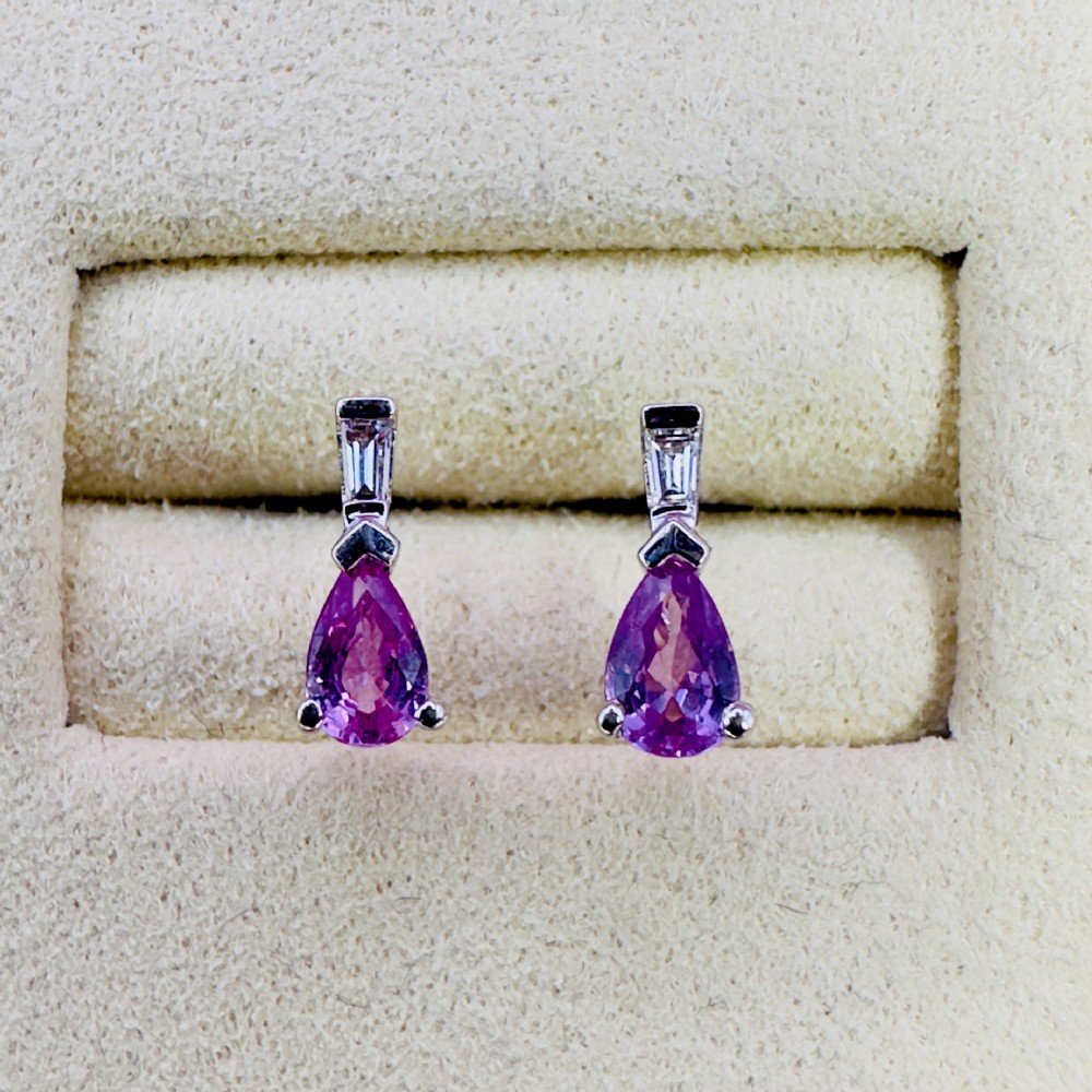 A pair of 18ct white gold stud earrings featuring pear-cut pink sapphires suspended beneath trapezoid-cut diamonds. View II