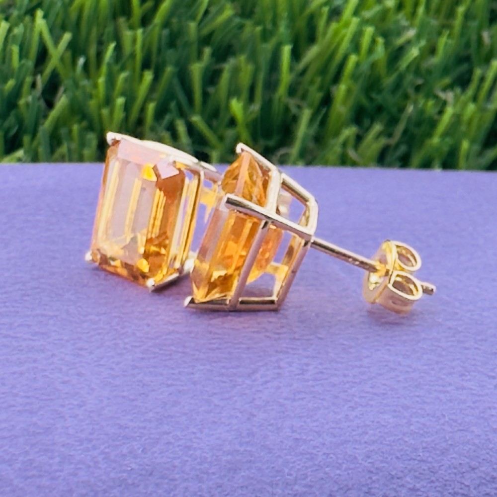 A pair of 14ct gold Art Deco stud earrings, each featuring a claw-set, emerald-cut golden yellow citrine gemstone. View VI