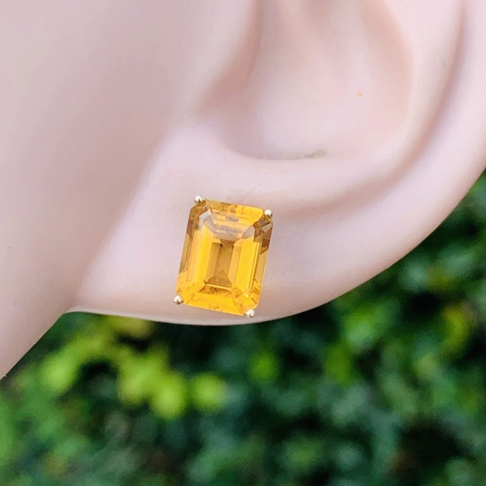 A pair of 14ct gold Art Deco stud earrings, each featuring a claw-set, emerald-cut golden yellow citrine gemstone. View IX