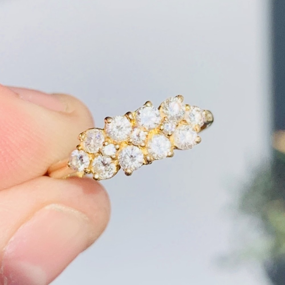An 18ct yellow gold Art Deco cluster ring set with ten old European cut diamonds arranged in a contoured multi-row setting. View II