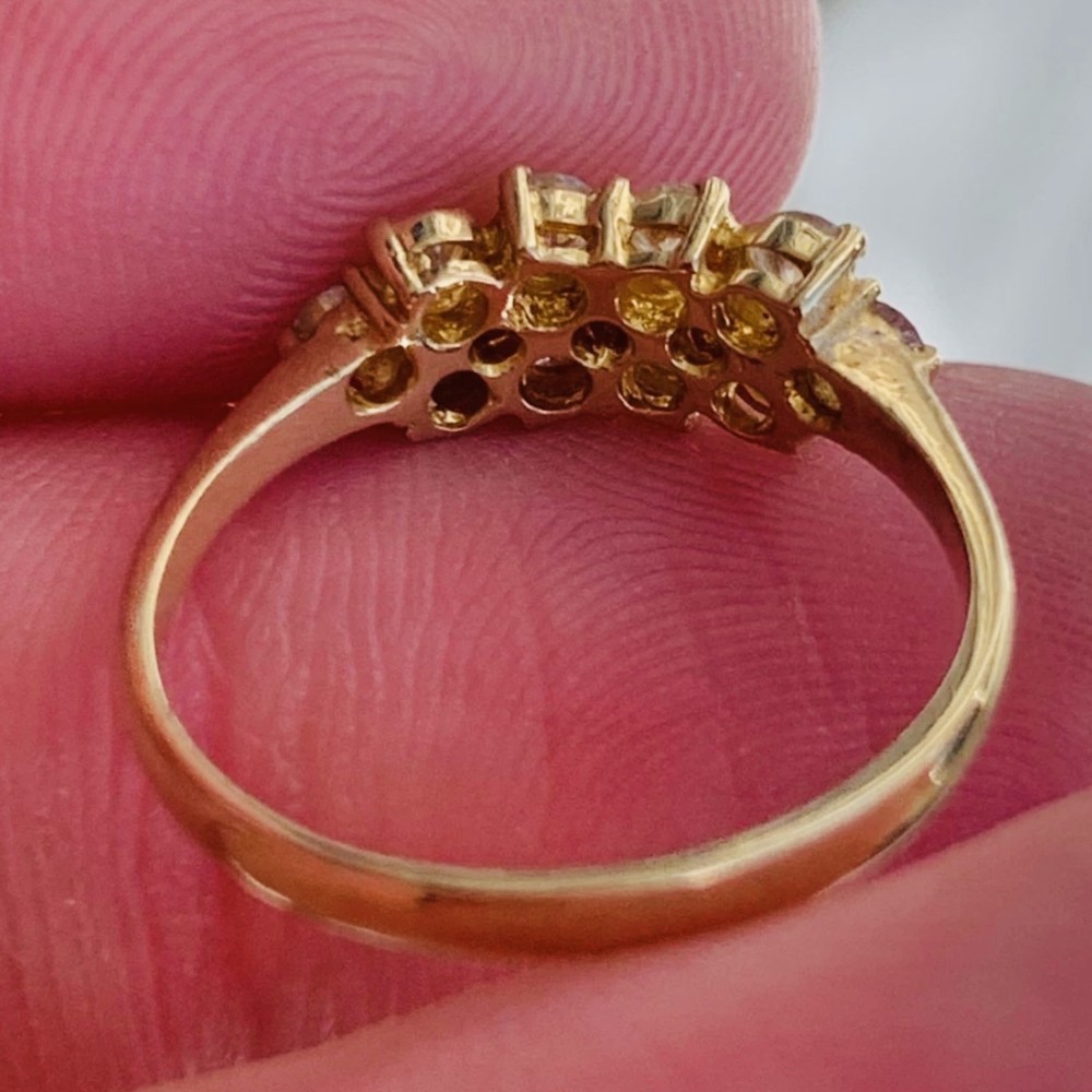 An 18ct yellow gold Art Deco cluster ring set with ten old European cut diamonds arranged in a contoured multi-row setting. View VI