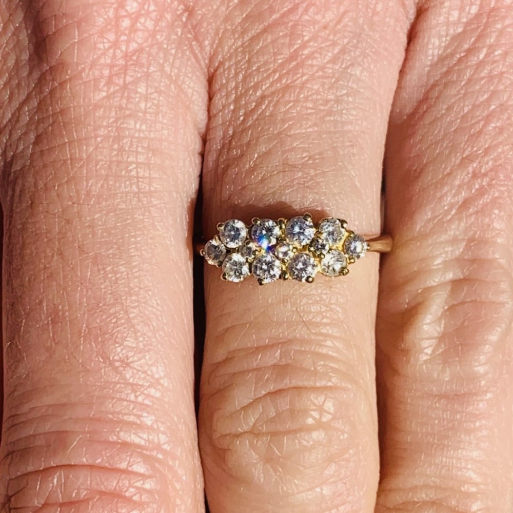 An 18ct yellow gold Art Deco cluster ring set with ten old European cut diamonds arranged in a contoured multi-row setting. View VII
