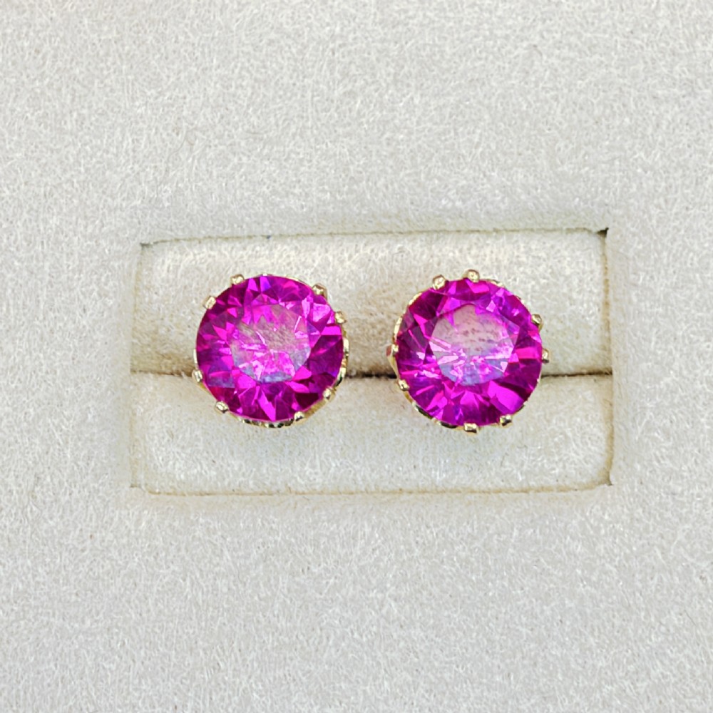 A pair of round pink sapphire gemstone stud earrings set in 18ct yellow gold claw settings with screw backs. View V