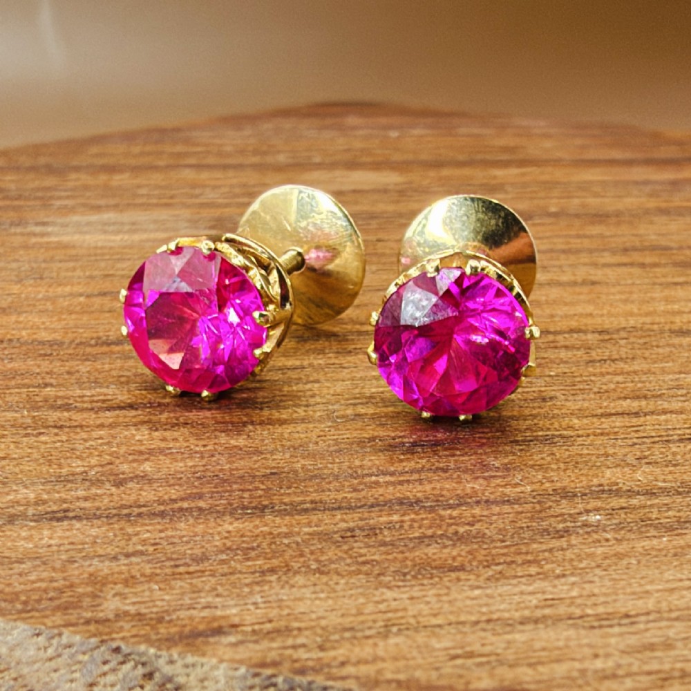 A pair of round pink sapphire gemstone stud earrings set in 18ct yellow gold claw settings with screw backs. View VII