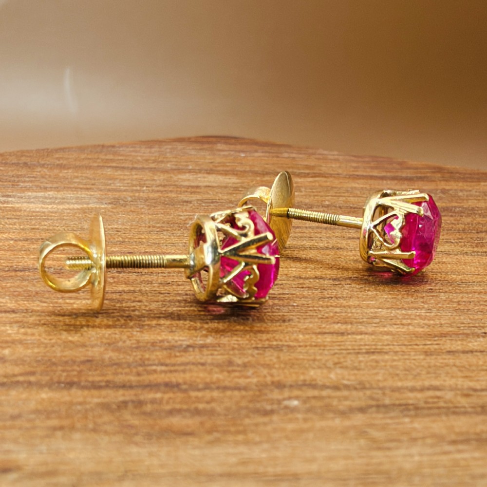 A pair of round pink sapphire gemstone stud earrings set in 18ct yellow gold claw settings with screw backs. View VIII