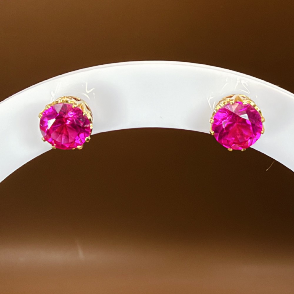 A pair of round pink sapphire gemstone stud earrings set in 18ct yellow gold claw settings with screw backs. View X