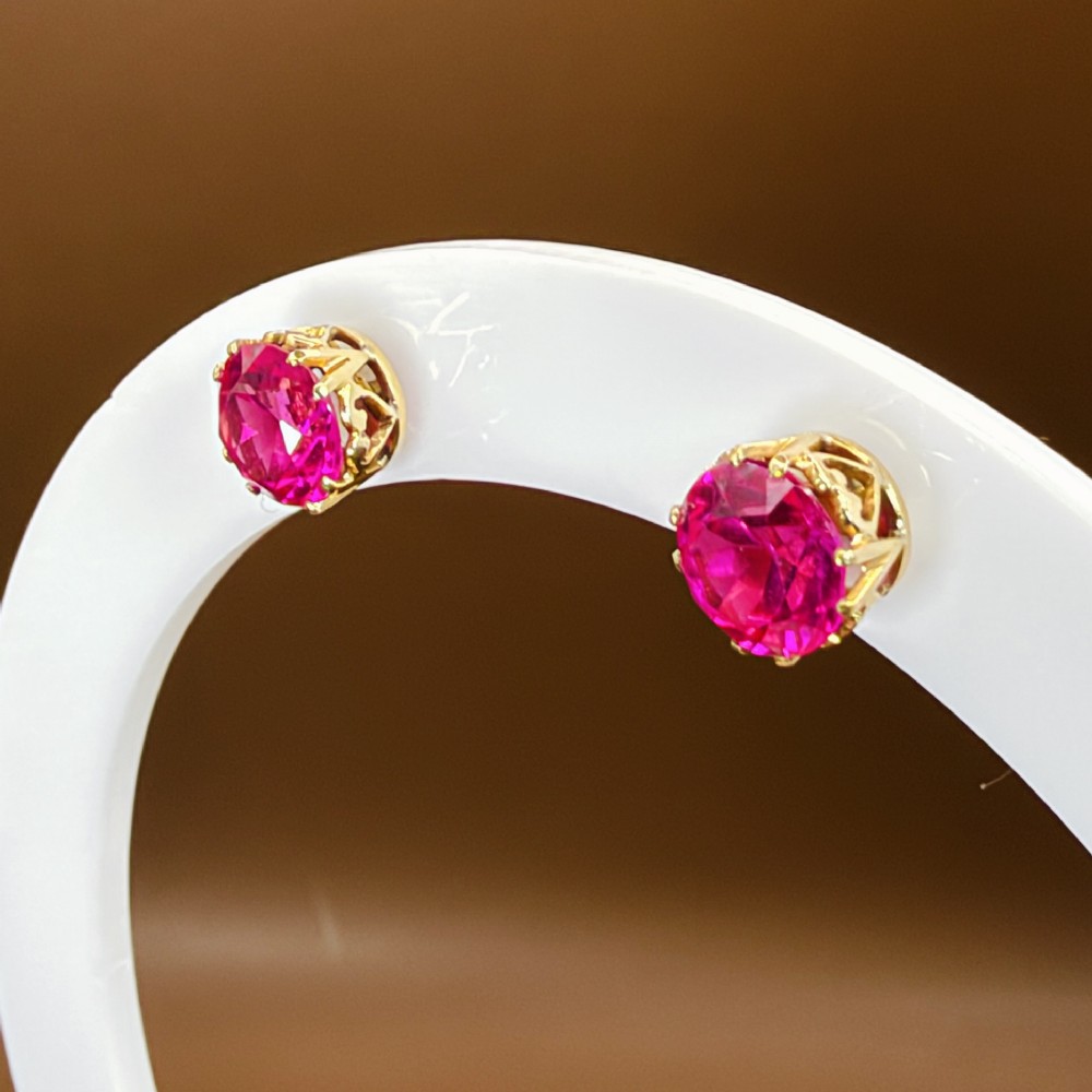 A pair of round pink sapphire gemstone stud earrings set in 18ct yellow gold claw settings with screw backs. View XI
