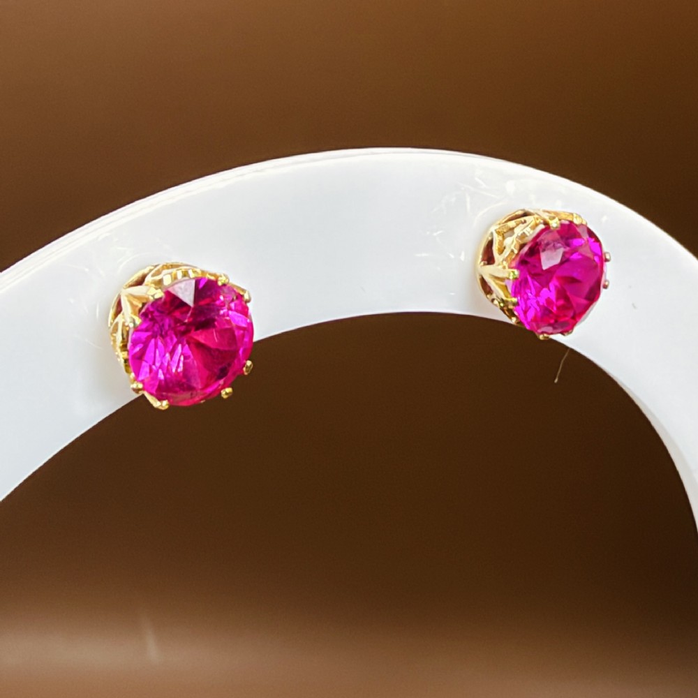 A pair of round pink sapphire gemstone stud earrings set in 18ct yellow gold claw settings with screw backs. View XII