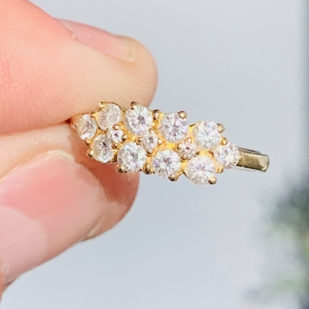 An 18ct yellow gold Art Deco cluster ring set with ten old European cut diamonds arranged in a contoured multi-row setting. View IV