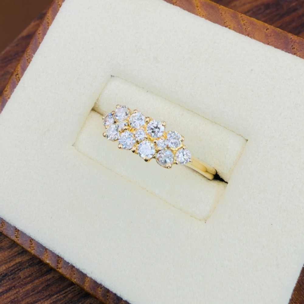 An 18ct yellow gold Art Deco cluster ring set with ten old European cut diamonds arranged in a contoured multi-row setting. View VII