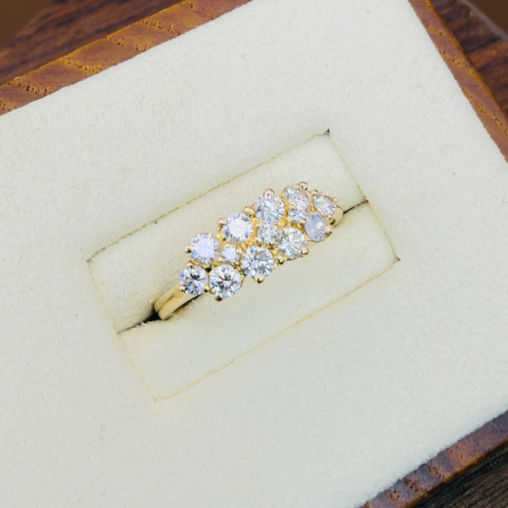 An 18ct yellow gold Art Deco cluster ring set with ten old European cut diamonds arranged in a contoured multi-row setting. View VIII