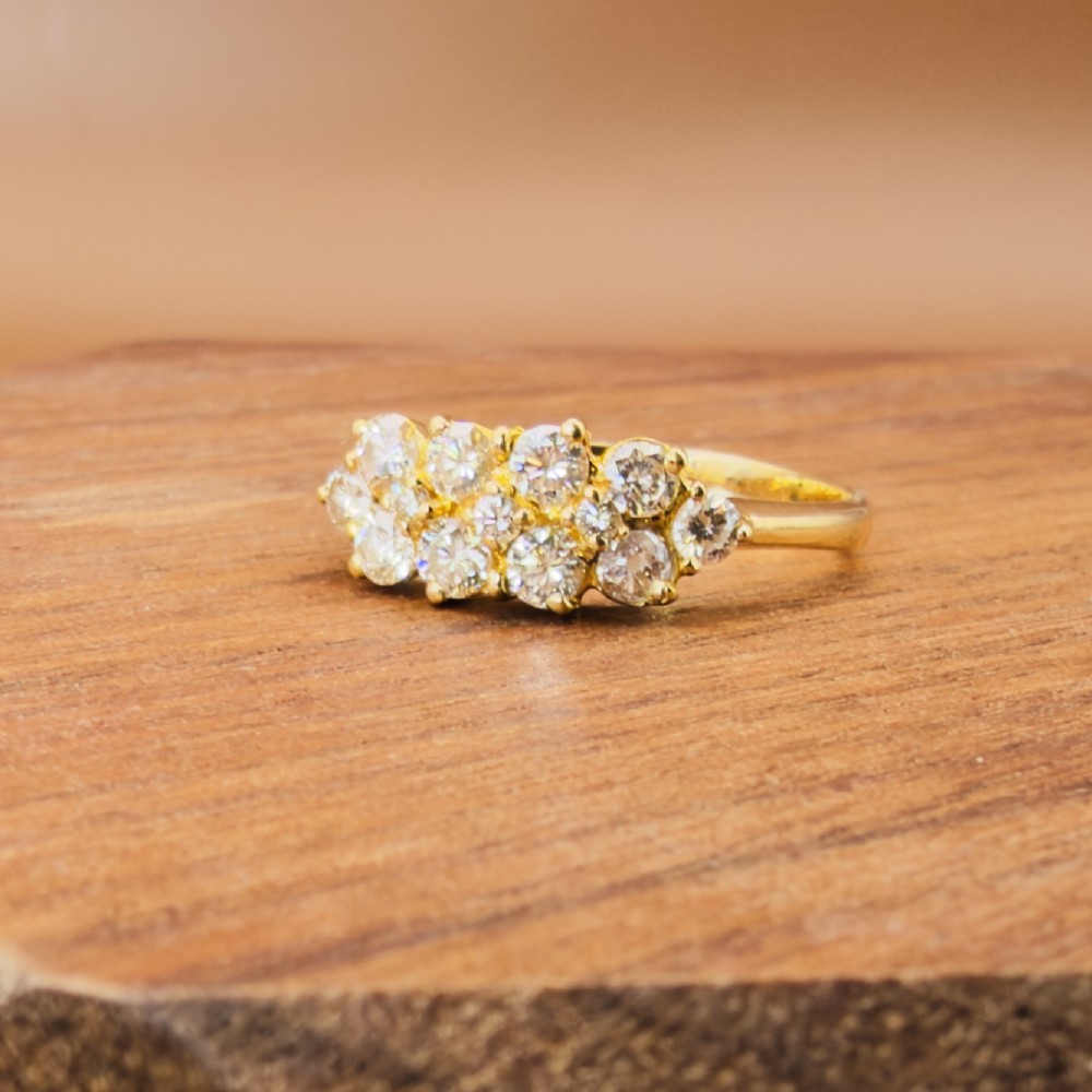 An 18ct yellow gold Art Deco cluster ring set with ten old European cut diamonds arranged in a contoured multi-row setting. View IX