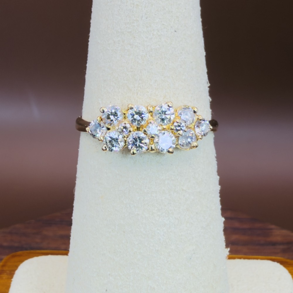 An 18ct yellow gold Art Deco cluster ring set with ten old European cut diamonds arranged in a contoured multi-row setting. View XI