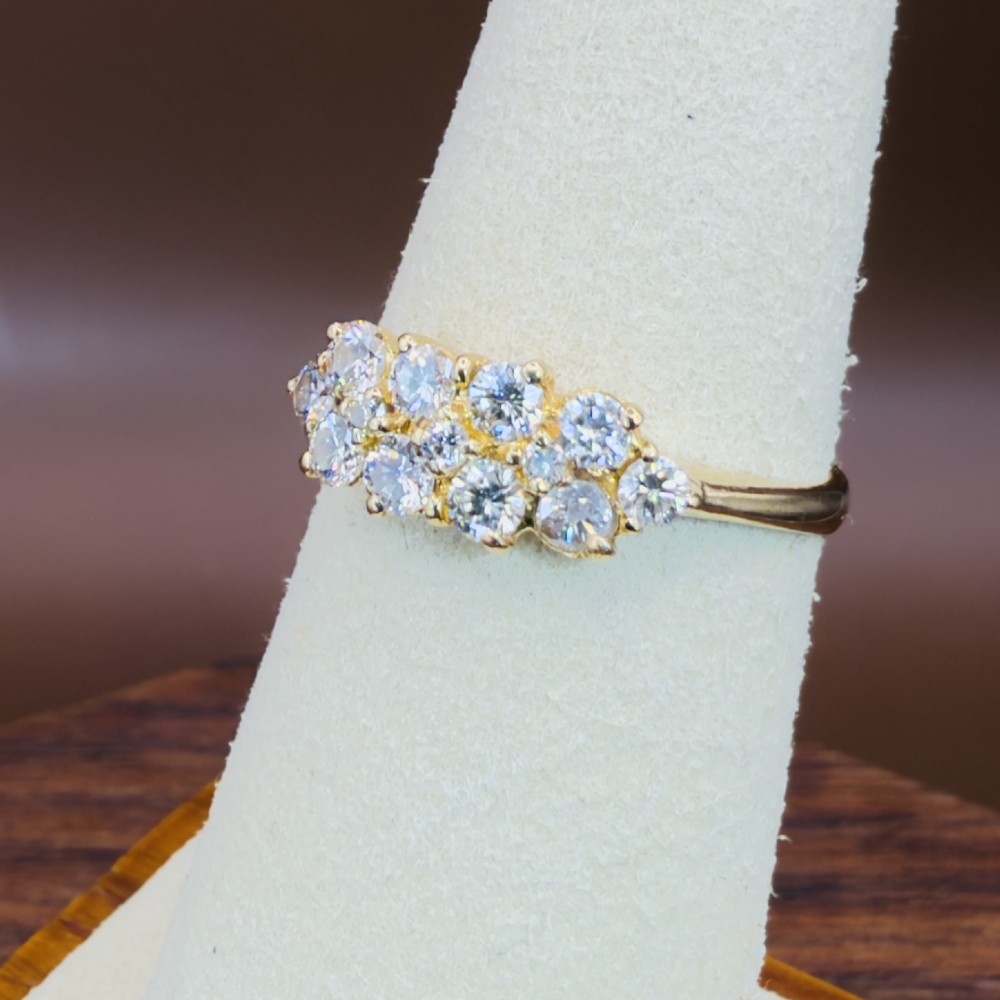 An 18ct yellow gold Art Deco cluster ring set with ten old European cut diamonds arranged in a contoured multi-row setting. View XII