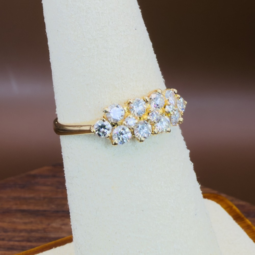 An 18ct yellow gold Art Deco cluster ring set with ten old European cut diamonds arranged in a contoured multi-row setting. View XIII