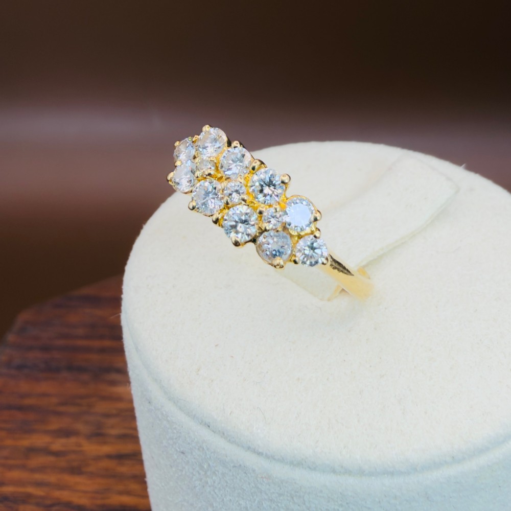 An 18ct yellow gold Art Deco cluster ring set with ten old European cut diamonds arranged in a contoured multi-row setting. View XIV